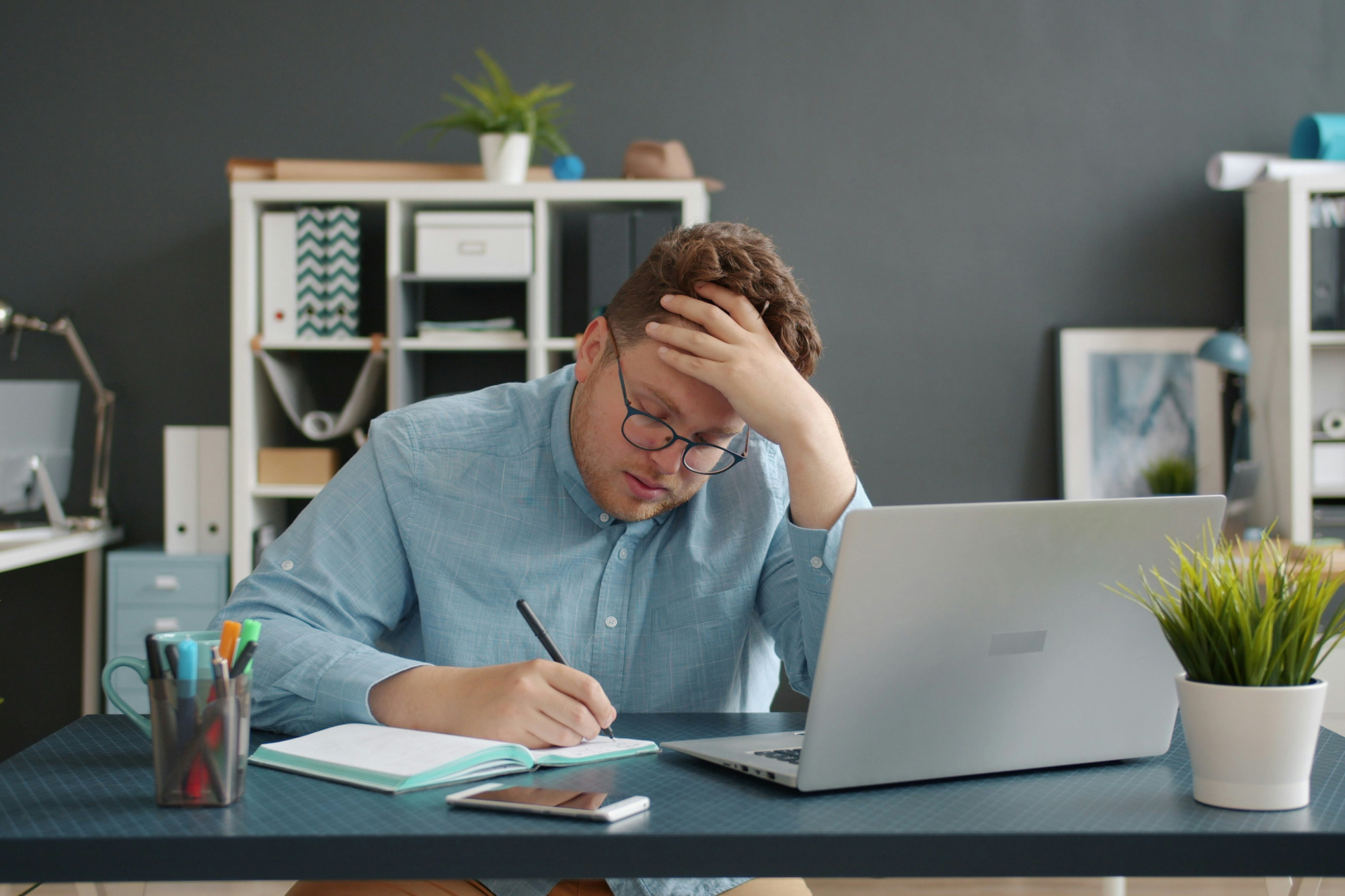 Stressed business owner working at desk trying to improve business performance.
