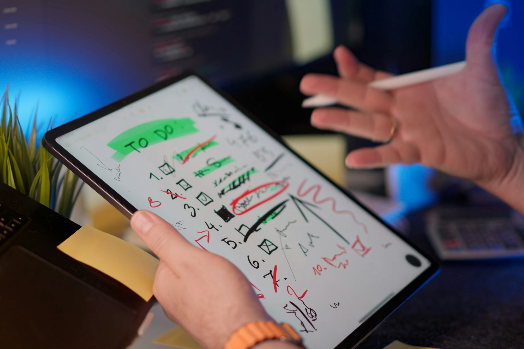 Man holding a tablet that is displaying an overwhelming to do list instead of employing leadership and delegation.