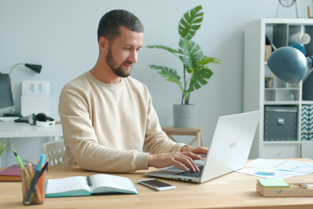 Business owner reviewing his calendar management system on laptop.