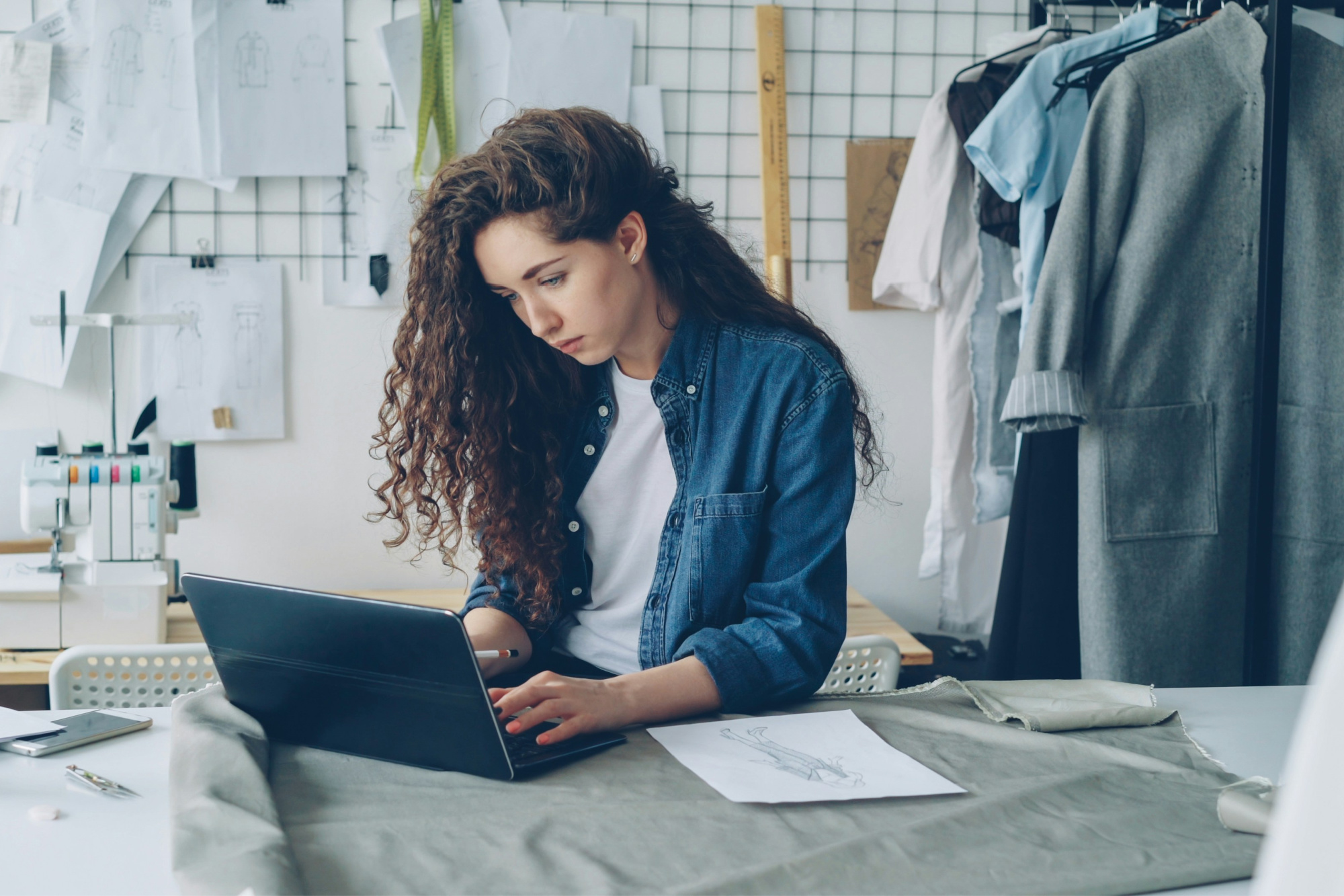 Small business owner reviewing business exit strategy plans in her workshop.