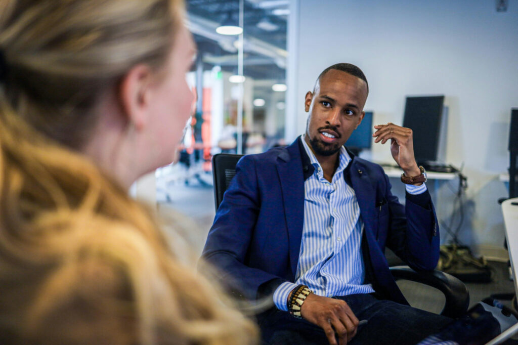 People sitting down and having a sales and marketing strategy conversation.