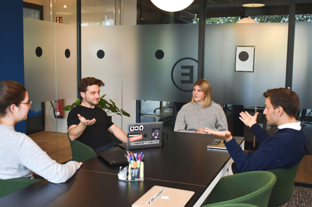 Small business team having a direct conversation about team accountability in a collaborative workspace.