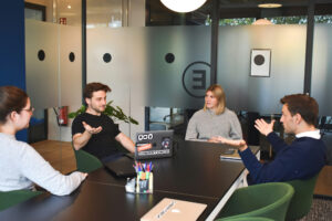 Small business team having a direct conversation about team accountability in a collaborative workspace.