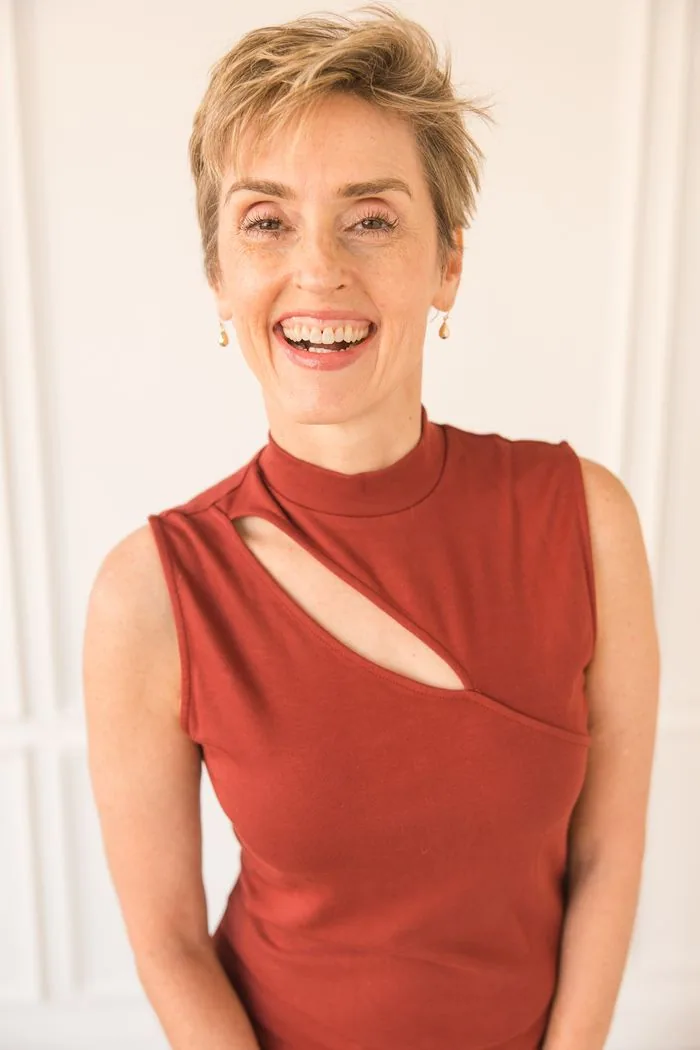 Karen Finn, PhD, smiling in a rust-red top